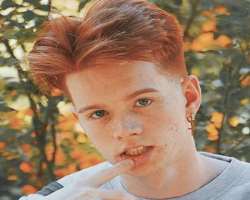 Cody has piercing on both ears on which he wears cross-shaped earrings.